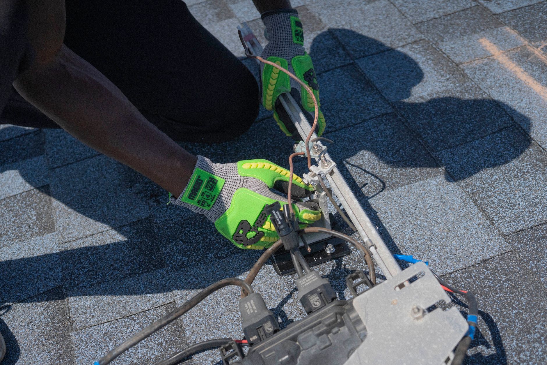 A skilled roofing technician from Bonita Roof Replacement & Repairs performing a detailed inspection on a residential roof in El Cajon, pointing out an area of concern to a homeowner.