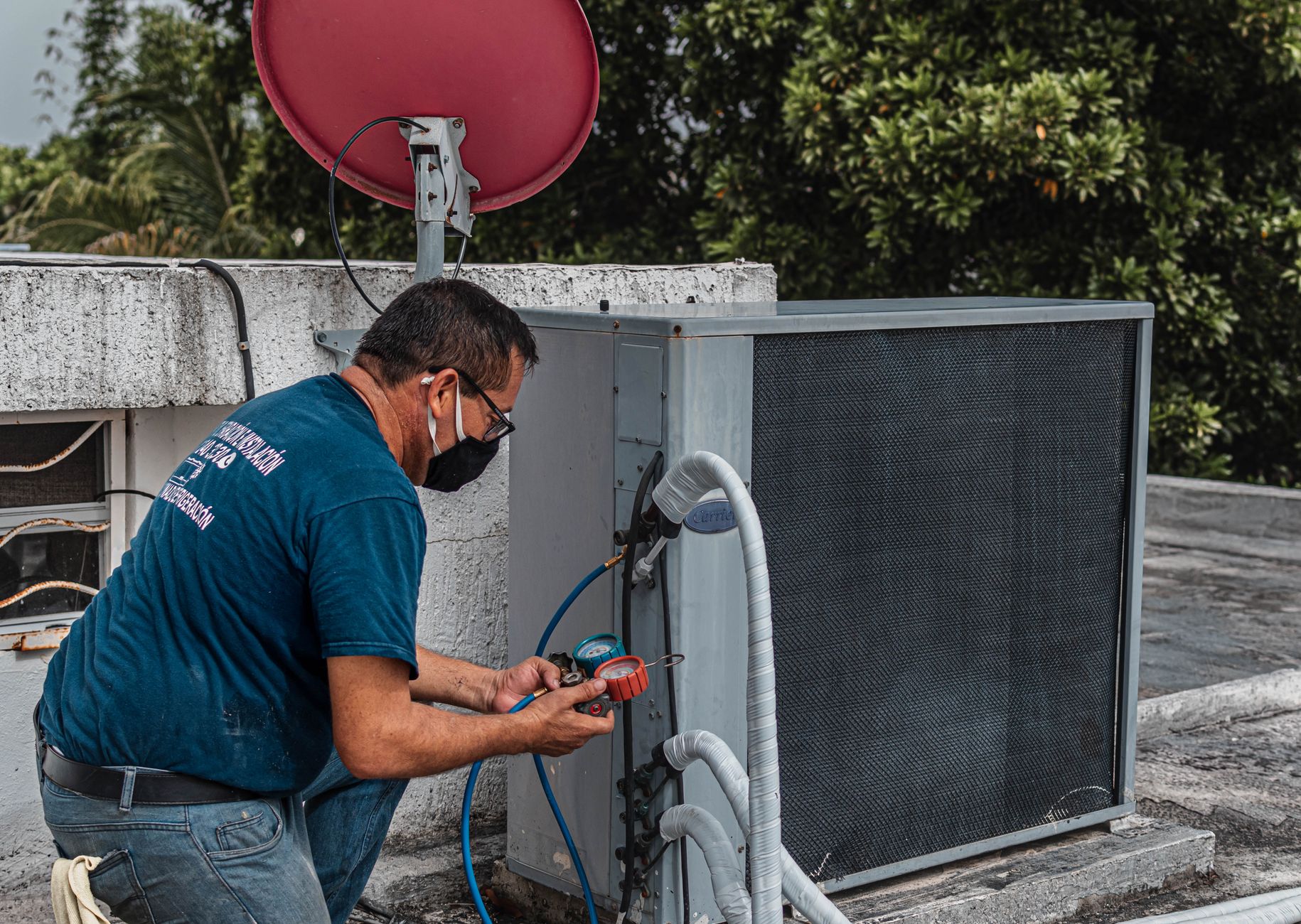 A professional roofer inspecting the integrity of an asphalt shingle roof on a residential home in Escondido.