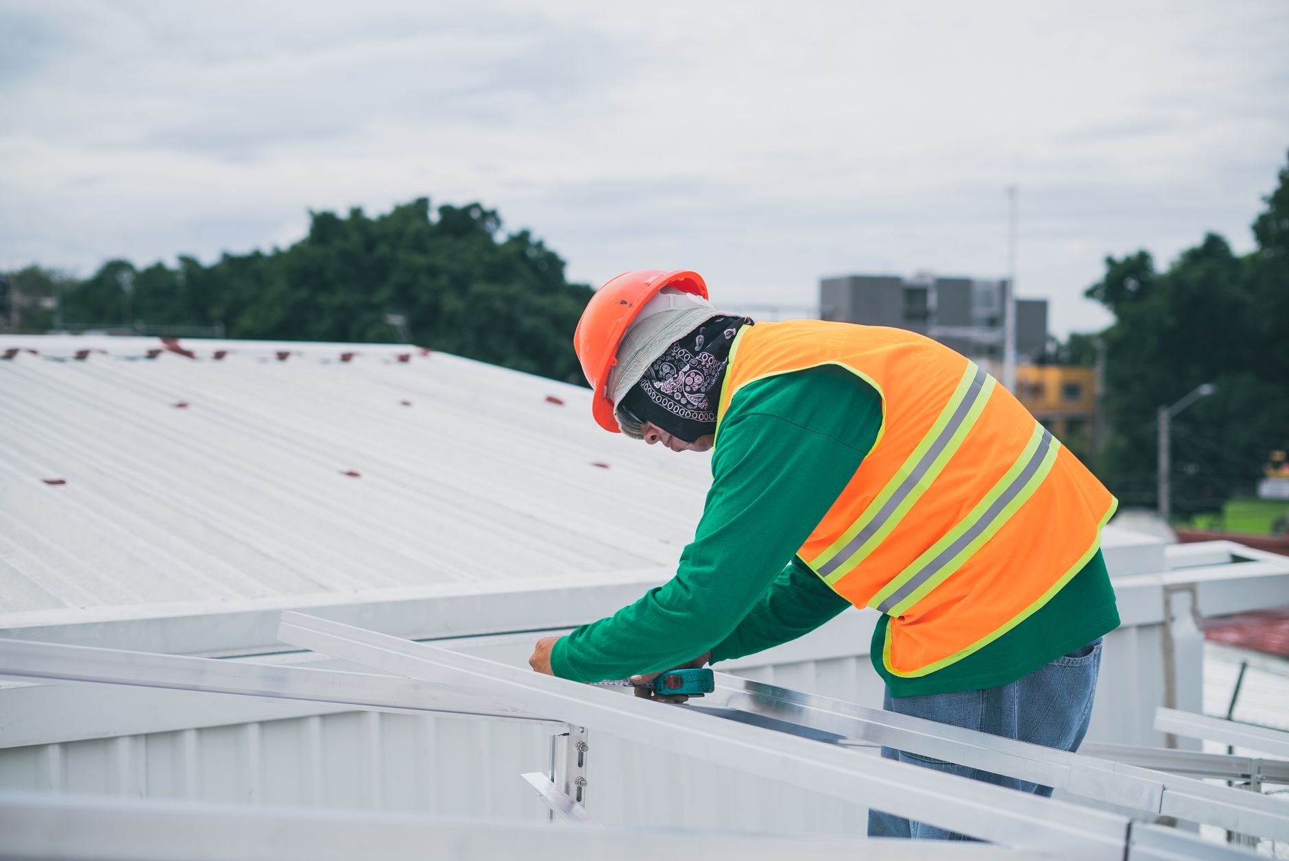 A Bonita Roof Replacement & Repairs team member reviewing blueprints on a job site in a National City neighborhood.