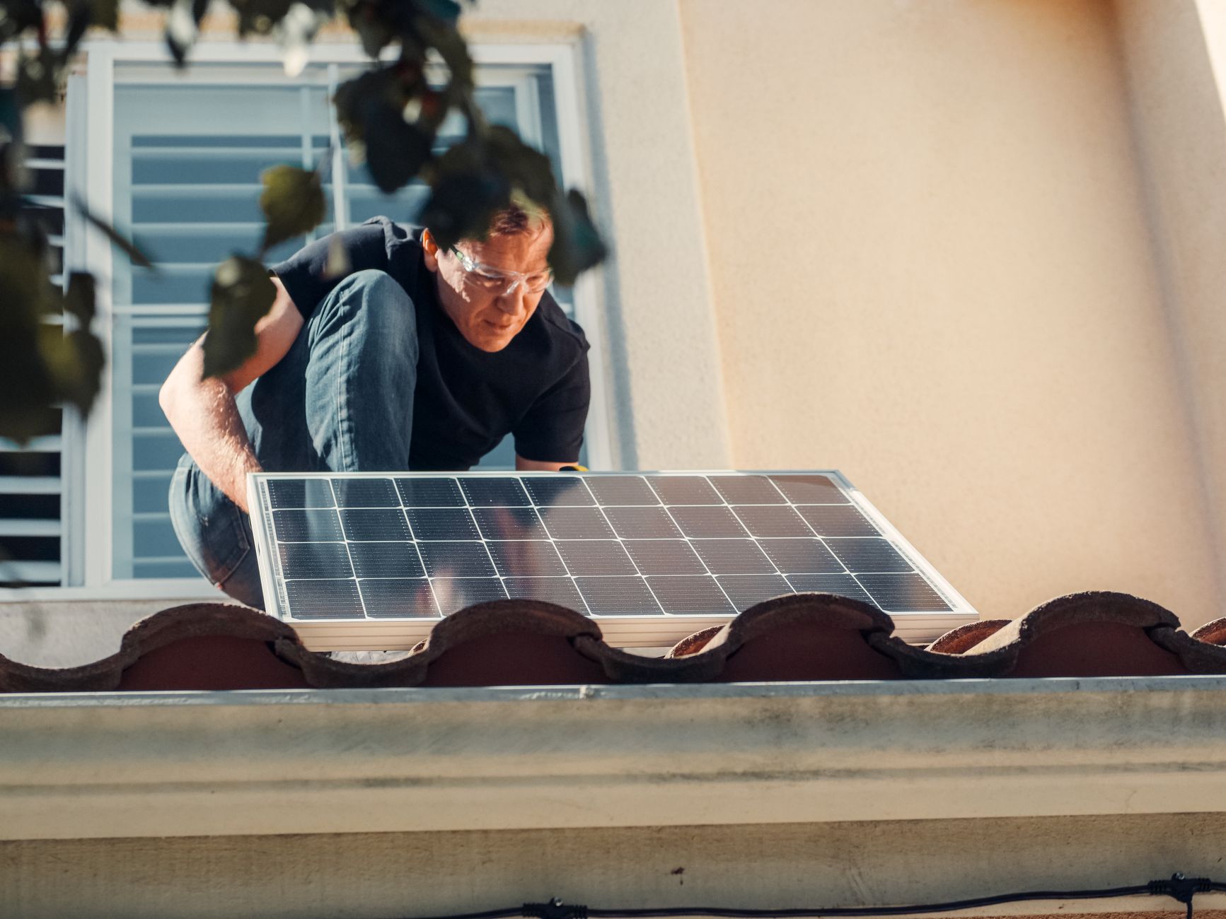 A Bonita Roof Replacement & Repairs team member reviewing blueprints on a Santee residential rooftop, with the city's hills in the background.