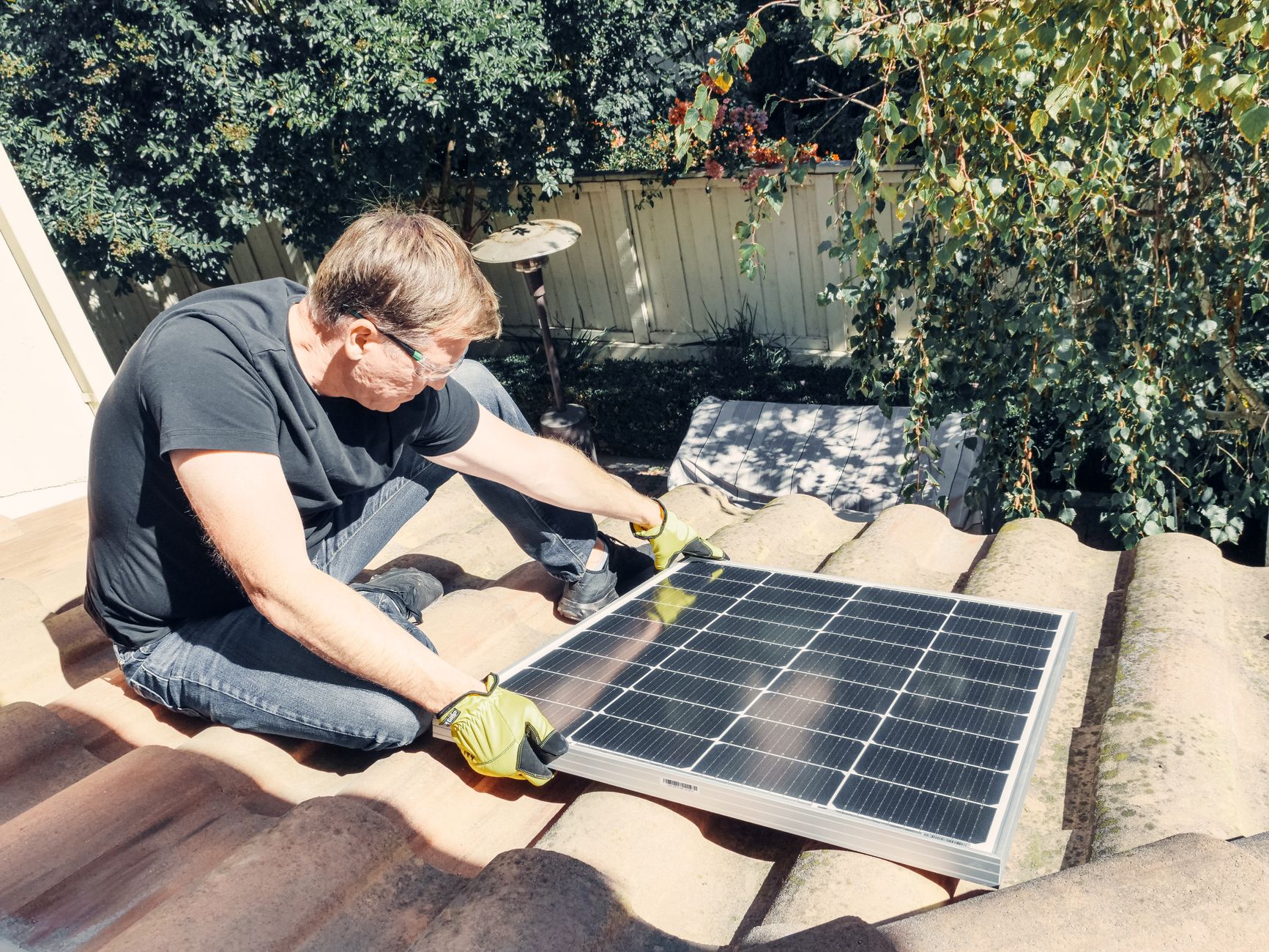 A professional roofer from Bonita Roof Replacement & Repairs performing a detailed inspection on a residential roof in Chula Vista, pointing out a potential issue.